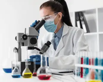 medium shot woman lookin through microscope