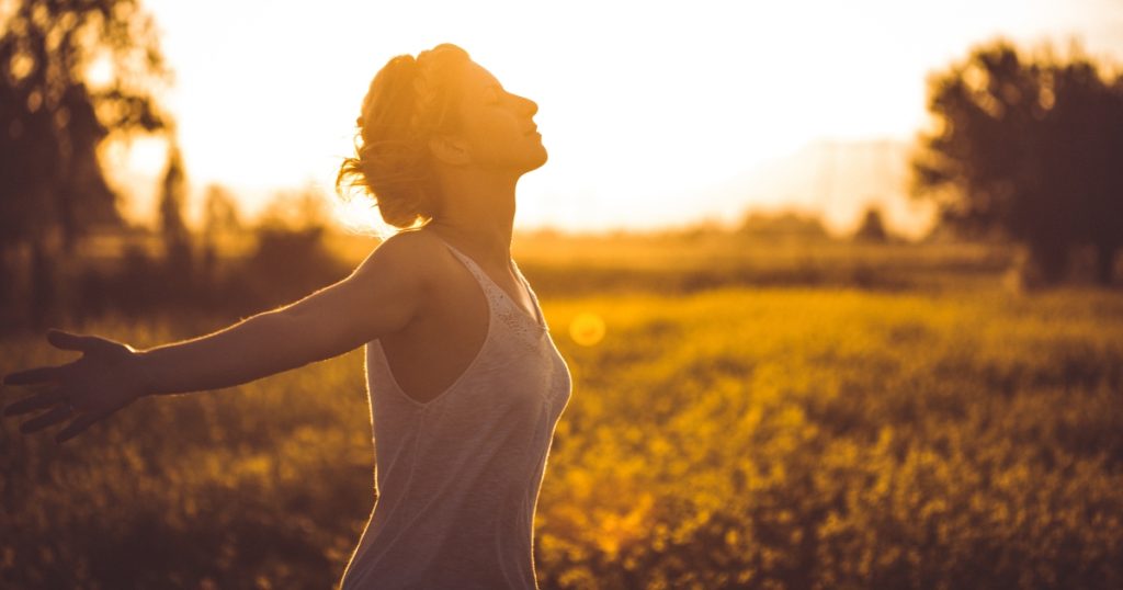 Person breathing freely in nature representing respiratory health and wellness