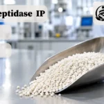 Serratiopeptidase IP enteric-coated granules in a laboratory scoop for pharmaceutical manufacturing